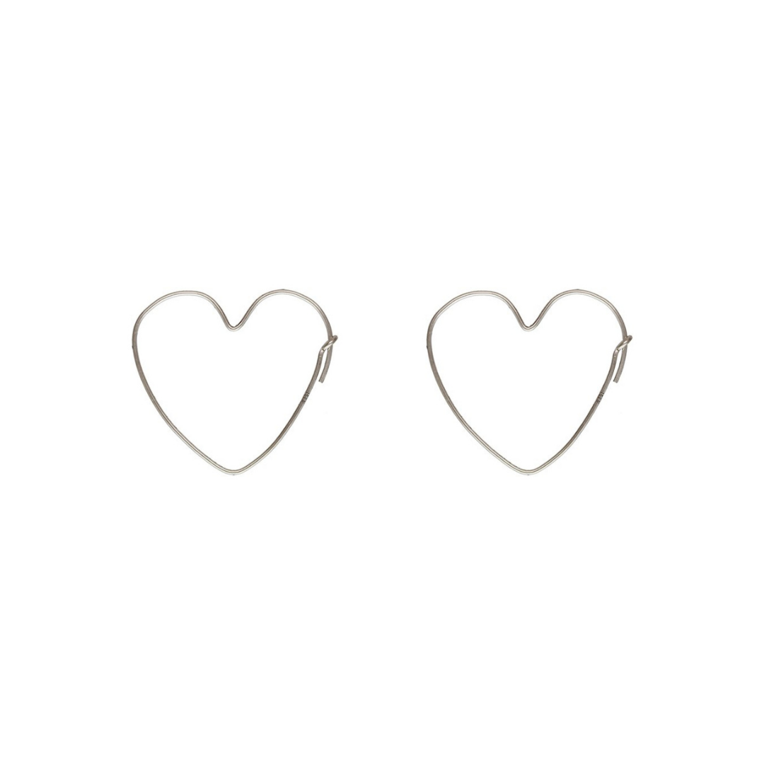 Heart shape silver earrings on a white background
