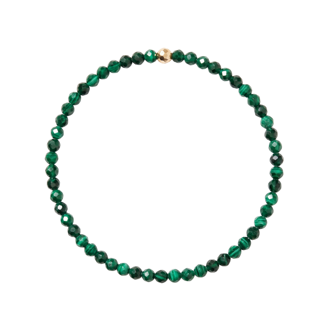 A beaded necklace made of faceted green malachite beads with a small gold accent bead at the top, shown on a plain white background.