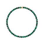 A beaded necklace made of faceted green malachite beads with a small gold accent bead at the top, shown on a plain white background.