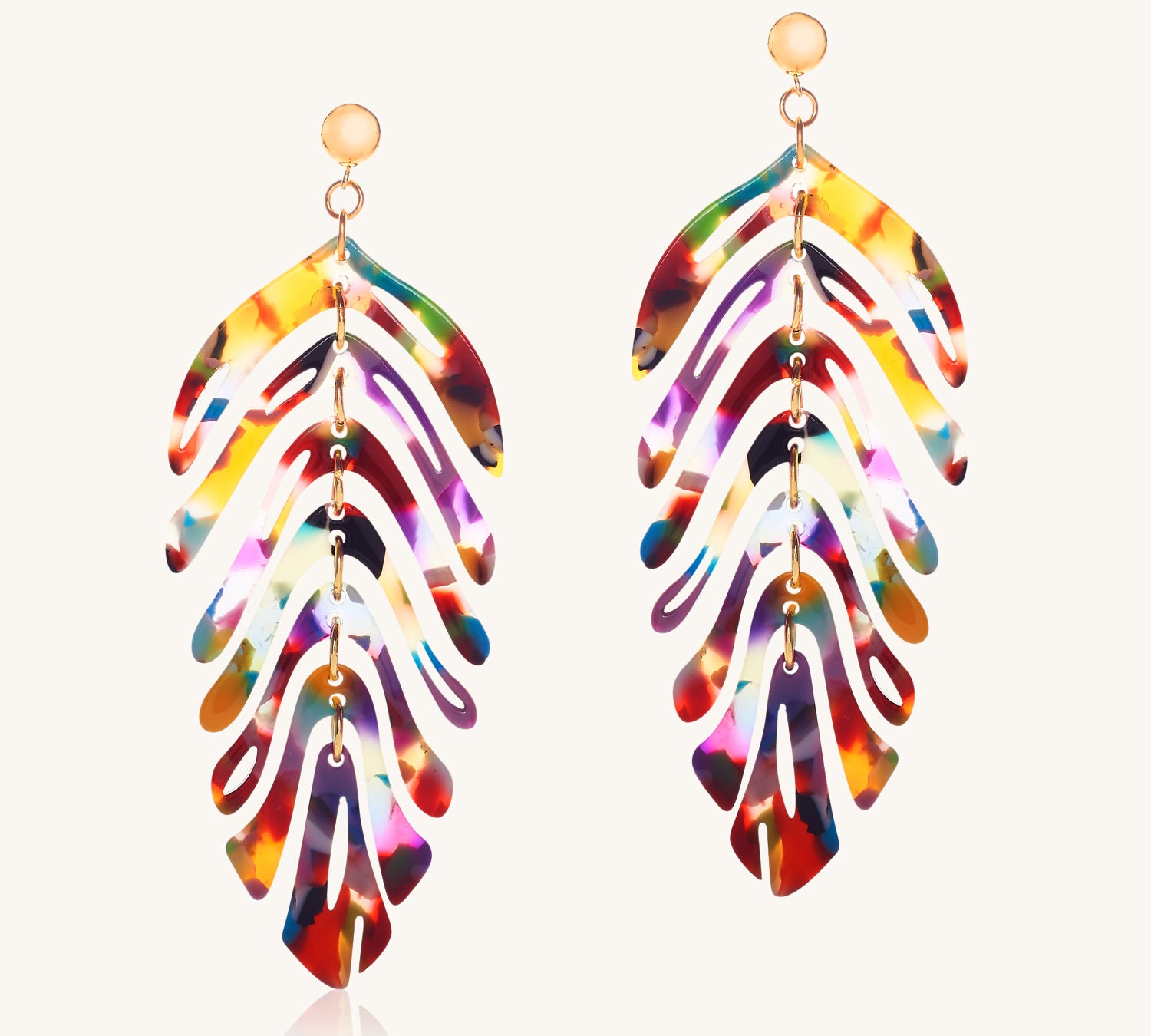 Colorful feather-shaped earrings on a white background