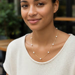 Gold necklace with pearls on a white background