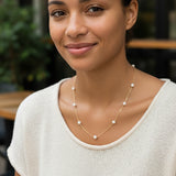 Gold necklace with pearls on a white background