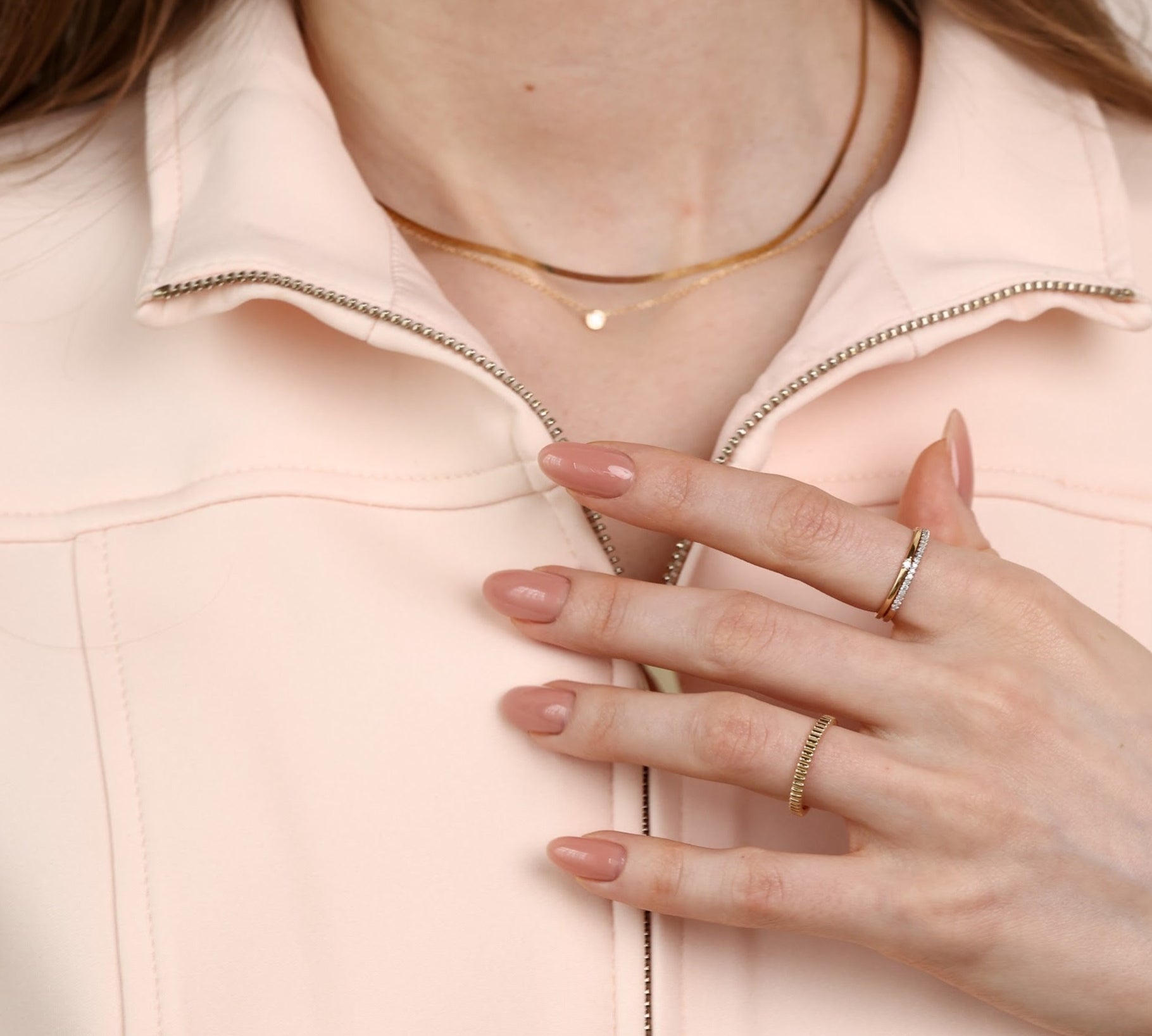 model posing with rings and hand to her chest